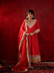 Woman in a red traditional outfit with gold embroidery against a red background